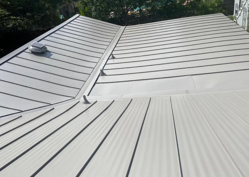 Solar attic fan installed on a metal roof for Roof Ventilation in Lombard
